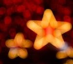 Blurred gold and red star-shaped lights creating a festive holiday atmosphere.